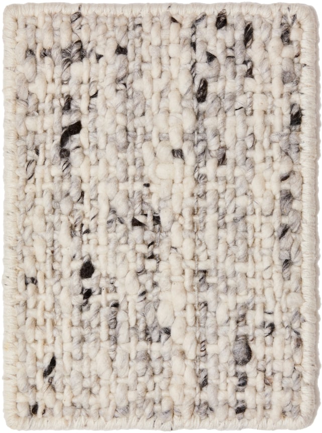 orchid sample in the panda color way. the sample features uneven thick corded yarns, woven together like a basket. the varying thickness in the weave gives it a very textural feel