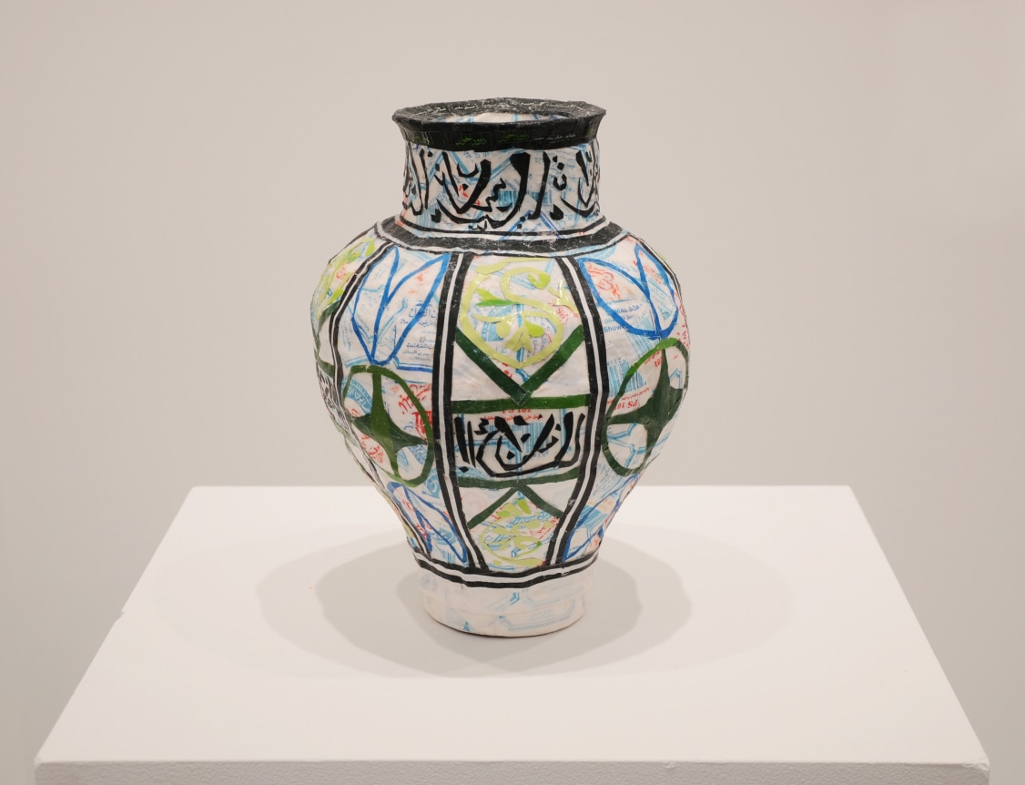 Michael Rakowitz,&nbsp;May The Obdurate Foe Not Be In Good Health:&nbsp;Glazed polychrome ceramic vase, 2017. Middle eastern packaging and newspapers, 13.2 x 10.5 inches.