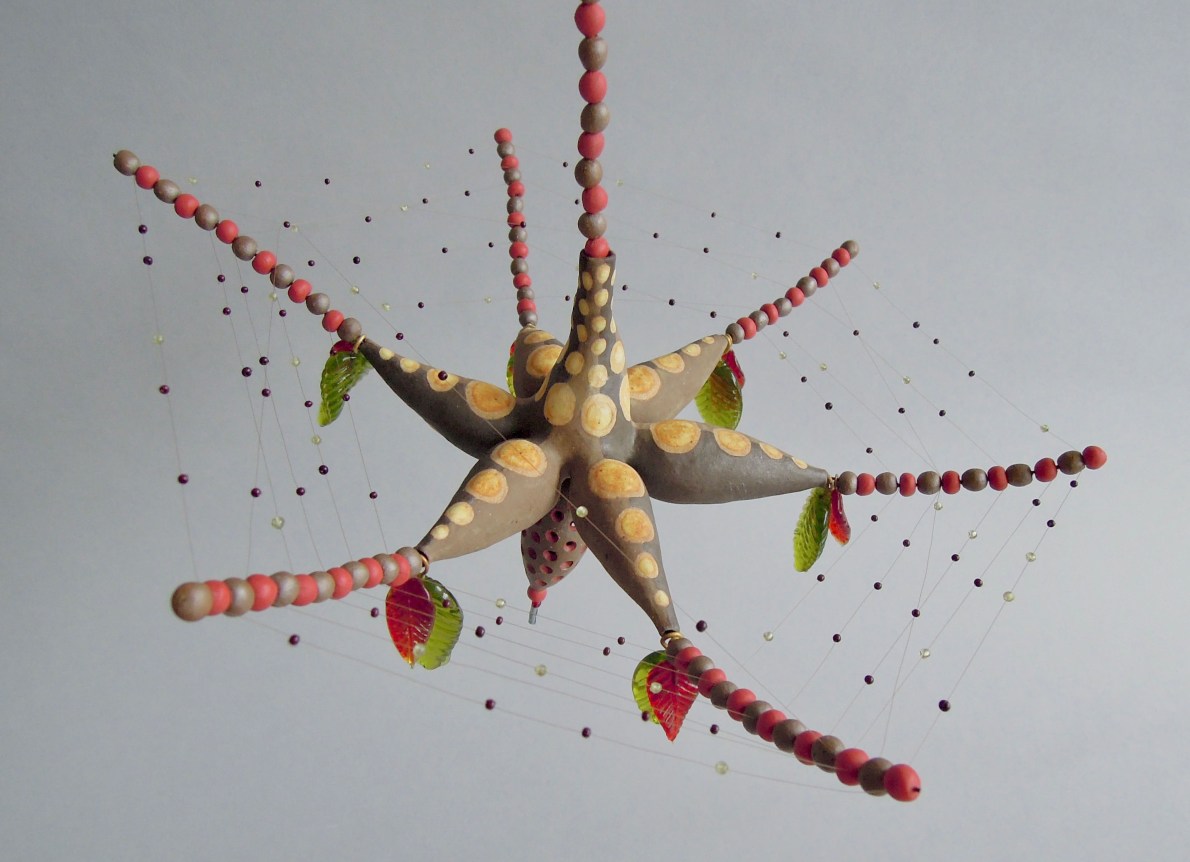 Chris Garofalo.&nbsp;giiwanimoshki&nbsp;wasabiig (liar&#039;s web),&nbsp;2020. Partially underglazed stoneware, glass leaves and beads, peridot beads, nylon thread, 11&nbsp;x 11&nbsp;x 7&nbsp;inches.&nbsp;