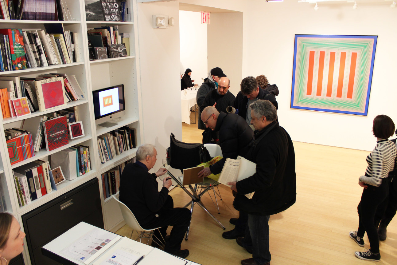 Richard Anuszkiewicz signing books