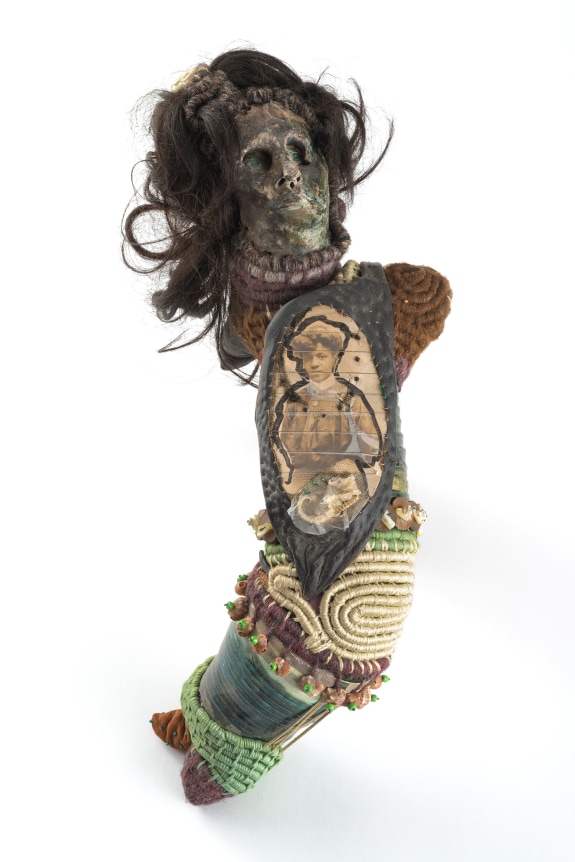 Joyce J. Scott Mammie Wada V, 1981 – 1978 mixed media, beads, thread, raffia, yarn, hair, leather, photograph and ink 14 x 18 x 10 inches (35.6 x 45.7 x 25.4 cm) (JJS78-02)
