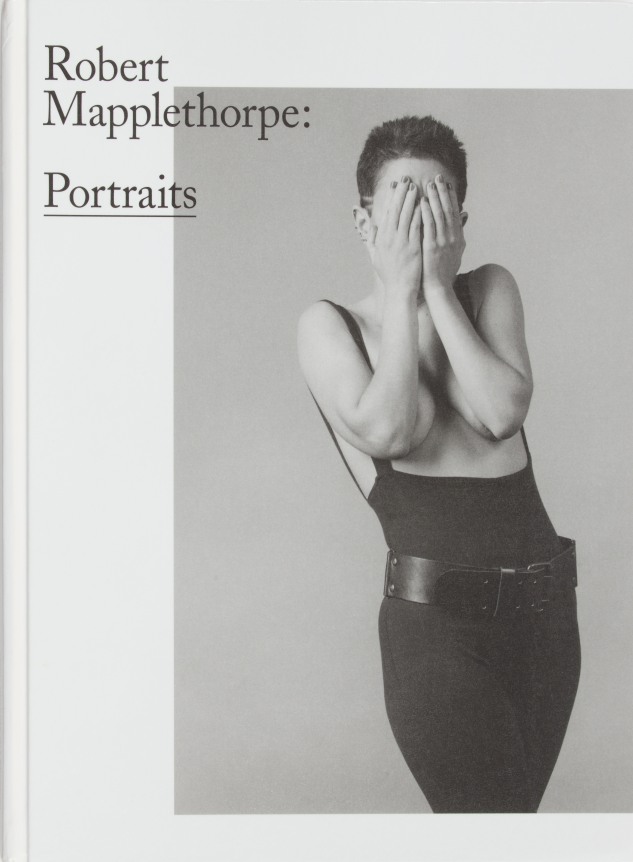 Portrait of Kathy Acker covering her face with her hands.