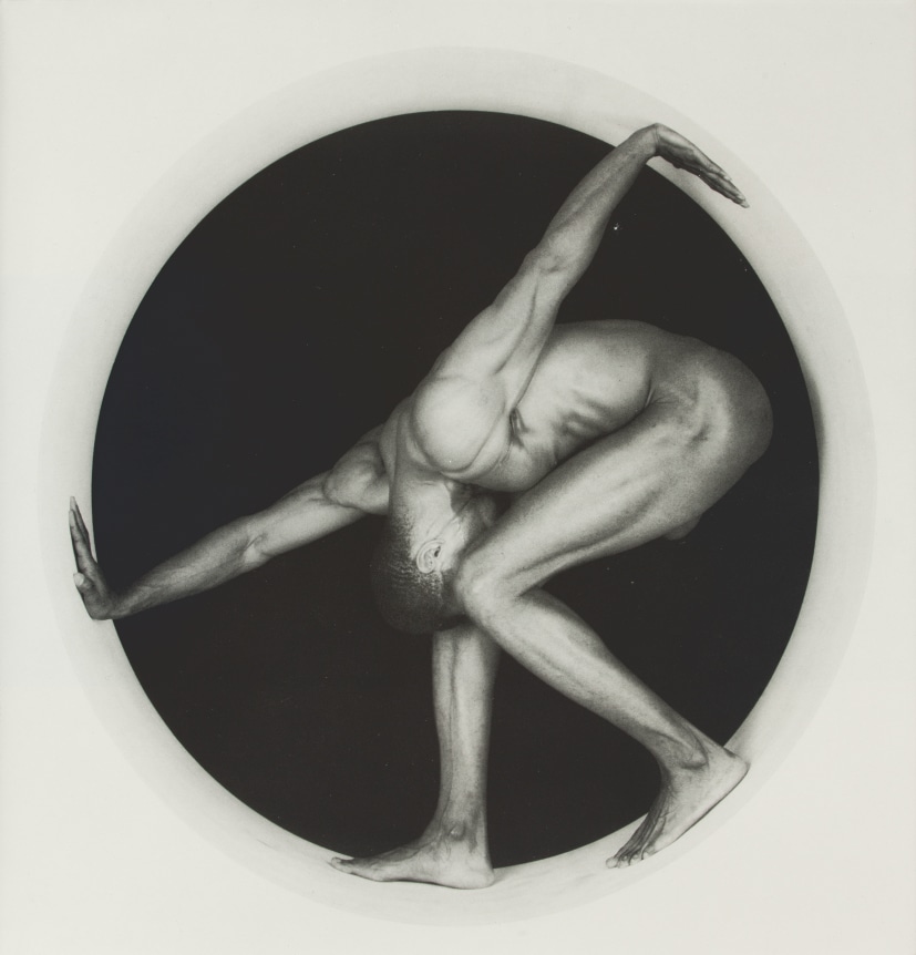 Portrait of Thomas in a Circle-crouching and pressing his hands against the edge.