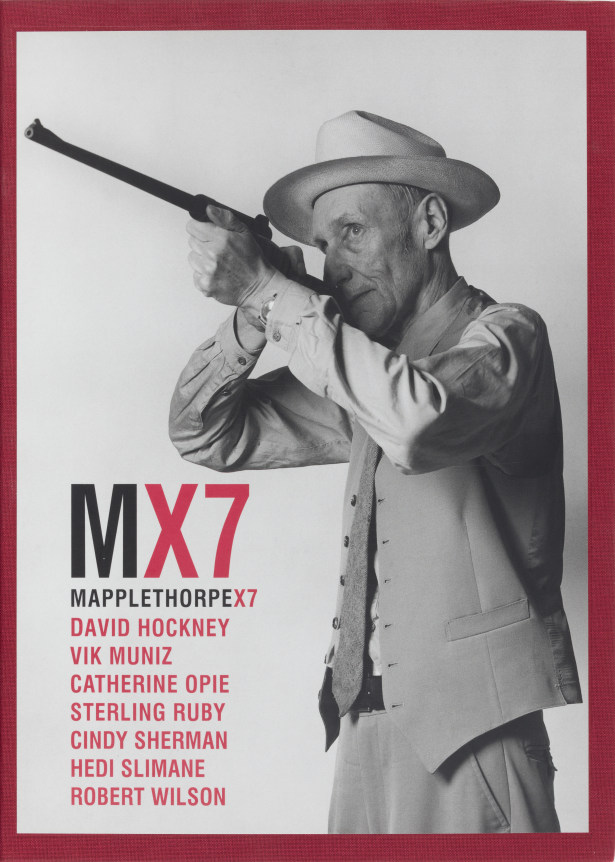 Portrtait of William Burroughs pointing a gun. Red text and red border around cover.