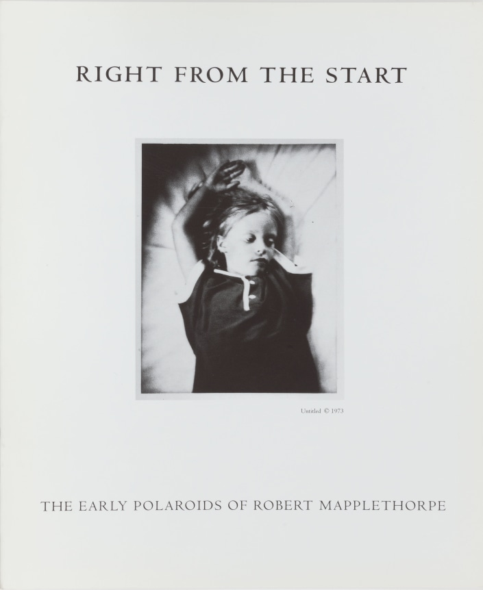 Polaroid image of a young girl, lying down with arms raised above her head.