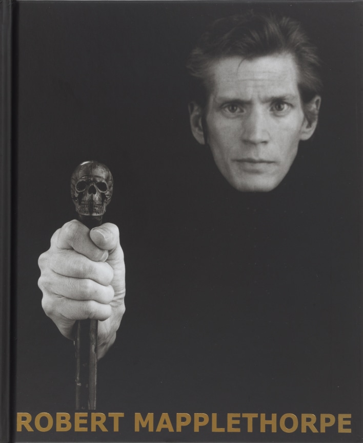 Self-Portrait with Skull Cane, and gold text at bottom of book.