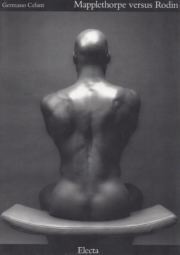 Ken Moody's photographed from behind, sitting on a stool.