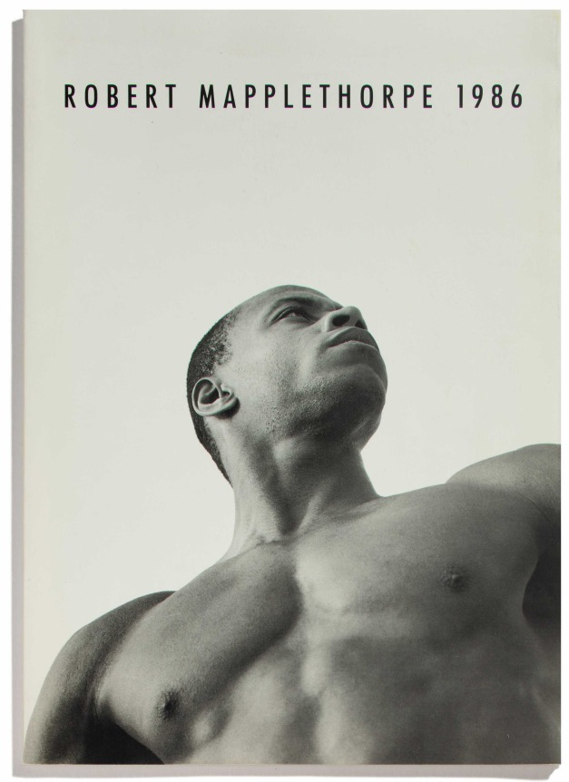 Portrait of a black man against a white background. Black text at top of page.