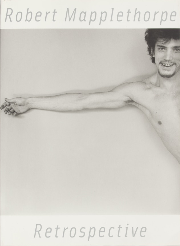 Self portrait with arm outstretched reaching to edge of frame, and a big grin.