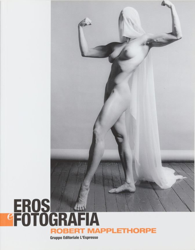 Lisa Lyon, naked, flexing her arms, head draped in gauze which trails down her back. Black and orange text.