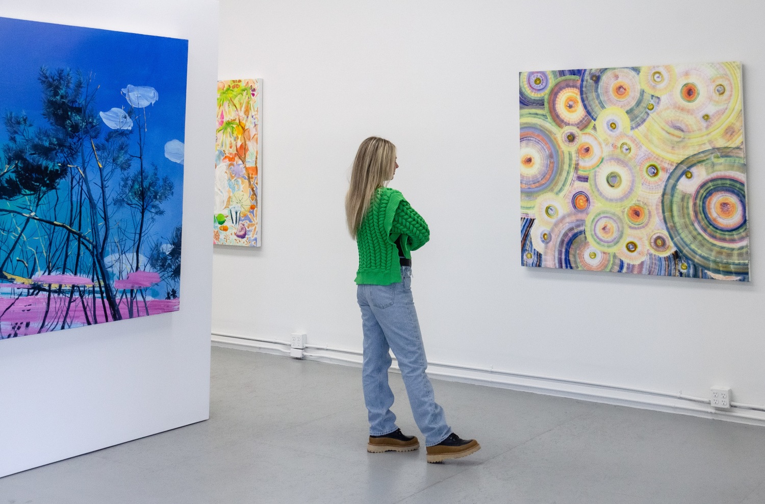 To the right, Danielle Riede, Sun shimmer Sound Check, 2020, Oil on Canvas, 50 x 57.25 in and to the left Claire McConaughty, Beach Pines, 2019, Oil on canvas, 60 x 72 in, $8,500