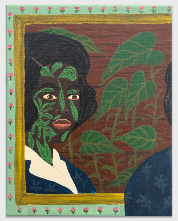 Reflected image of a woman in a mirror with vegetation tattoos and a floral border