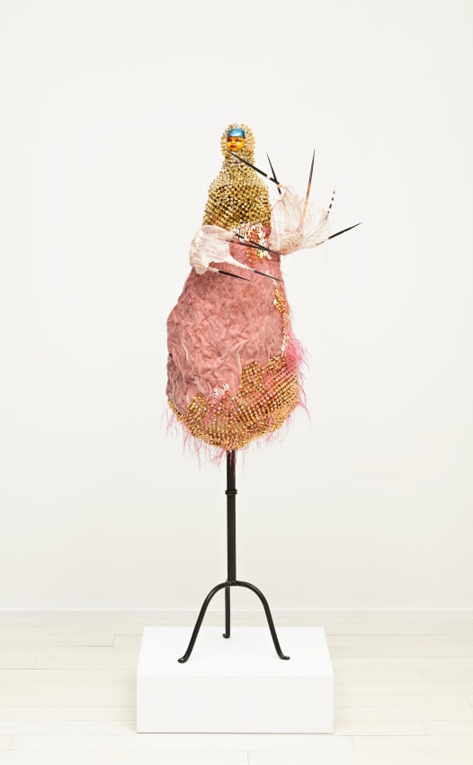 Rina Banerjee, Jack Fruit Johnny she was a Diasporic Devi who changed her name to taste like honey, changed her faith to sunny, changed sex to something funny, changed her city to New York City. -all for reason, to be far, far away, from misery and war and for money.,&nbsp;2015,&nbsp;Cotton thread, paper mache vessal base, steel stand, vintage porcelain doll head, silk fabric with printing, porcupine needles, silver blue leaf, plastic trim,&nbsp;56 x 18 x 20 in