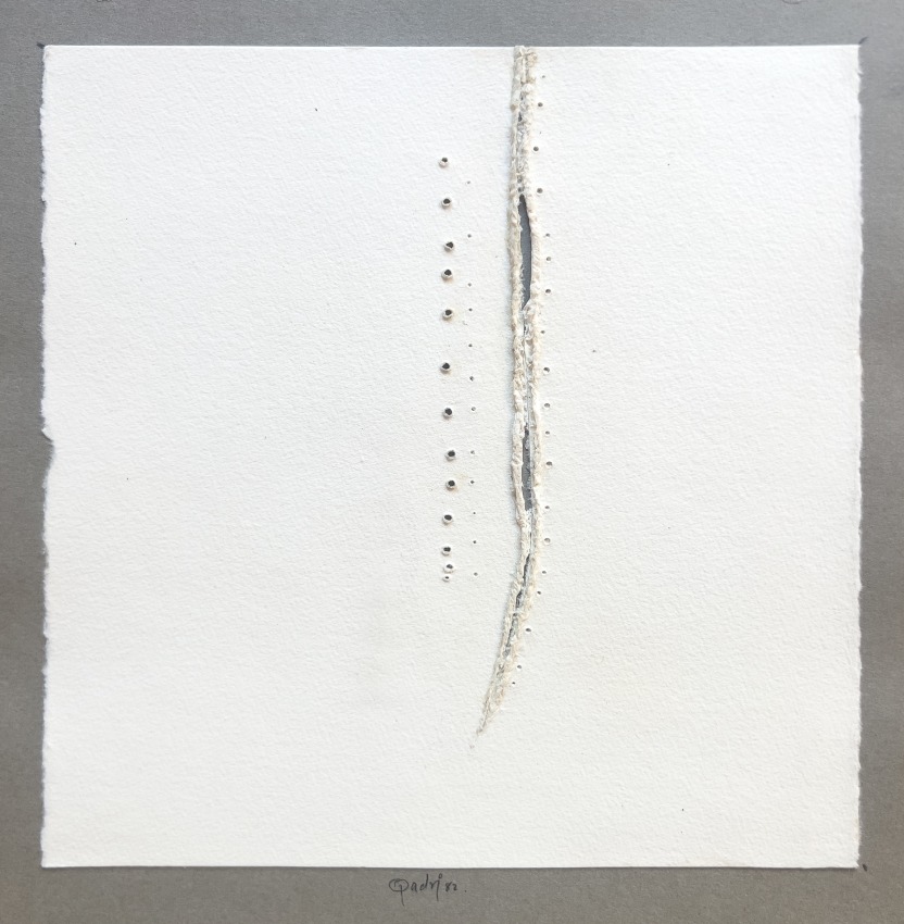 White paper with rip and holes