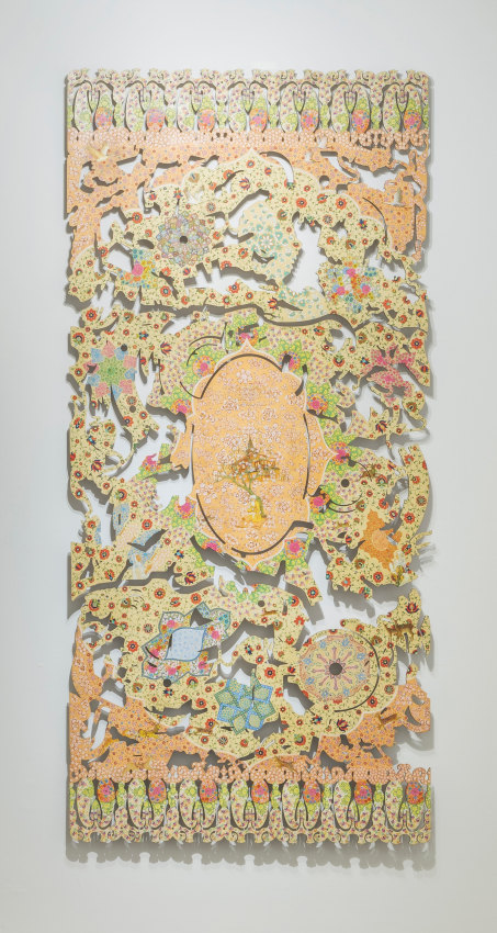 Hand painted wall sculpture carved in multiple shapes in orange, yellow, red orange tones with human figure in the middle