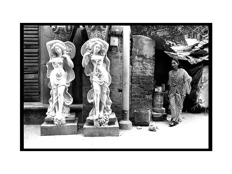 Sanjeet Chowdhury A TEA OWNER COMING OUT OF HER STALL IN KUMARTULLI