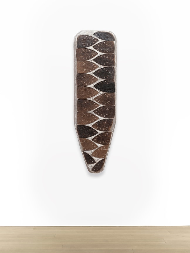 Willie Cole,&nbsp;Domestic Shield XVII, 2021, Iron scorches on canvas with resin, chalk and wax mounted on wood, 54 x 16 3/4 inches, 137.2 x 42.5 cm.&nbsp;Photo: Joerg Lohse. Image courtesy of&nbsp;Alexander and Bonin, New York.&nbsp;