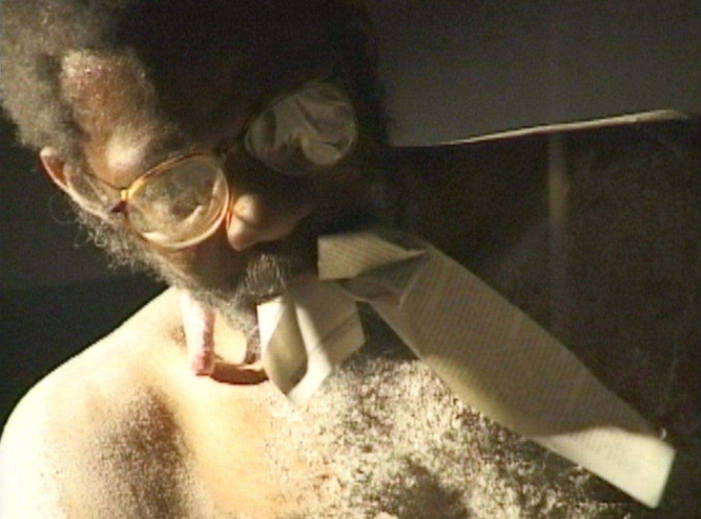 POPE.L  Still from Eating the Wall Street Journal (3rd Version) 2000