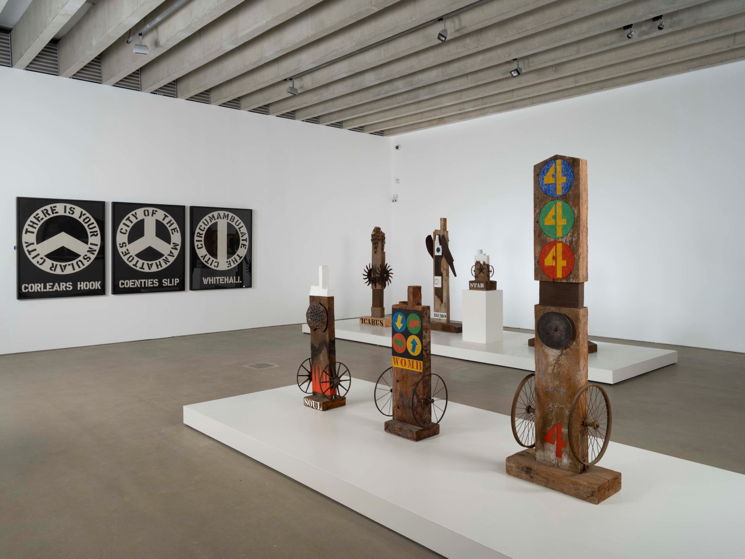 Installation view of the exhibition Robert Indiana: Sculpture 1958–2018 at the Yorkshire Sculpture Park, 2022, featuring six wooden sculptures and the painting The Melville Triptych