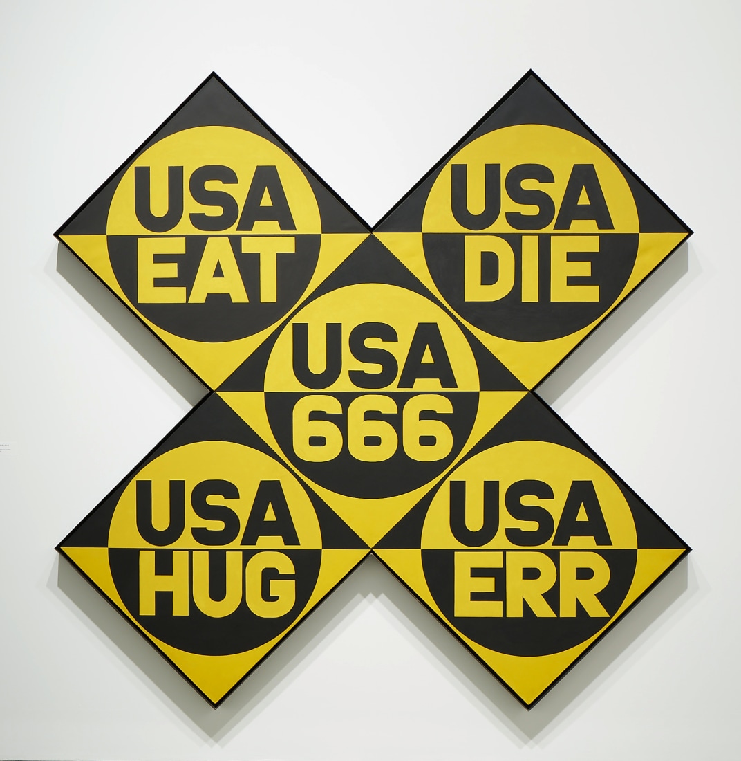 USA 666 (The Sixth American Dream), a yellow and black x-format painting, made up of five panels. Each panel has a circle divided in two, the top half yellow with USA painted in black, and the bottom black with a yellow word. The words are, clockwise from top left, "EAT,""DIE," "ERR," "HUG," and in the central panel "666."