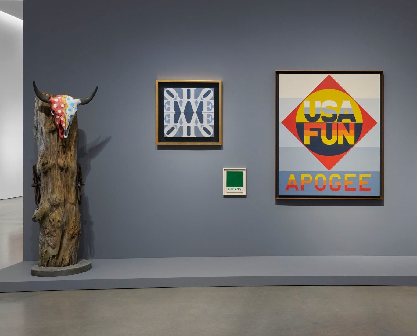 Installation view of Pace Gallery's Robert Indiana: The American Dream, with left to right, the sculpture USA, and the paintings LOVE Wall, Grass, and Apogee