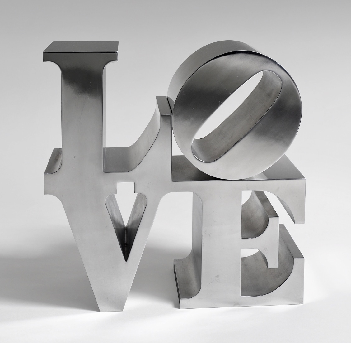 Robert Indiana's aluminum, hand-cut and mirror-finished LOVE sculpture, consisting of a letter L and a tilted letter O on top of the letters V and E.