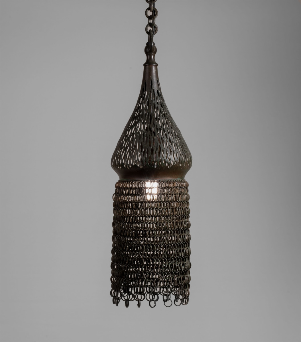 a tiffany studios hanging lantern formed by metal chainmail in the moorish style