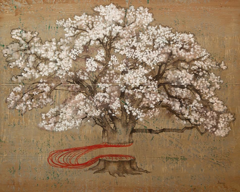 A cut cherry blossom held together by red strings in front of a gold background.