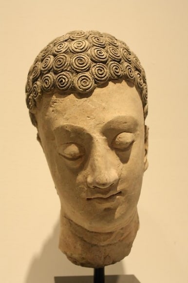 Head of Buddha 1 Ancient Region of Gandhara, Kushan Period 2nd/3rd Century Stucco with traces of pigment Height: 10 in. NFS