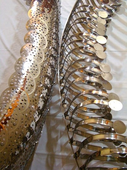 Adeela Suleman CONFLICTING SIDES 2009 Steel drain cover, steel tongs, nuts & bolts (two separate pieces but to be displayed as shown in image 1) Piece 1 (left) 81.5 x 14 x 22 (depth) in.; Piece 2 (right): 78 x 11 x 19 (depth) in.