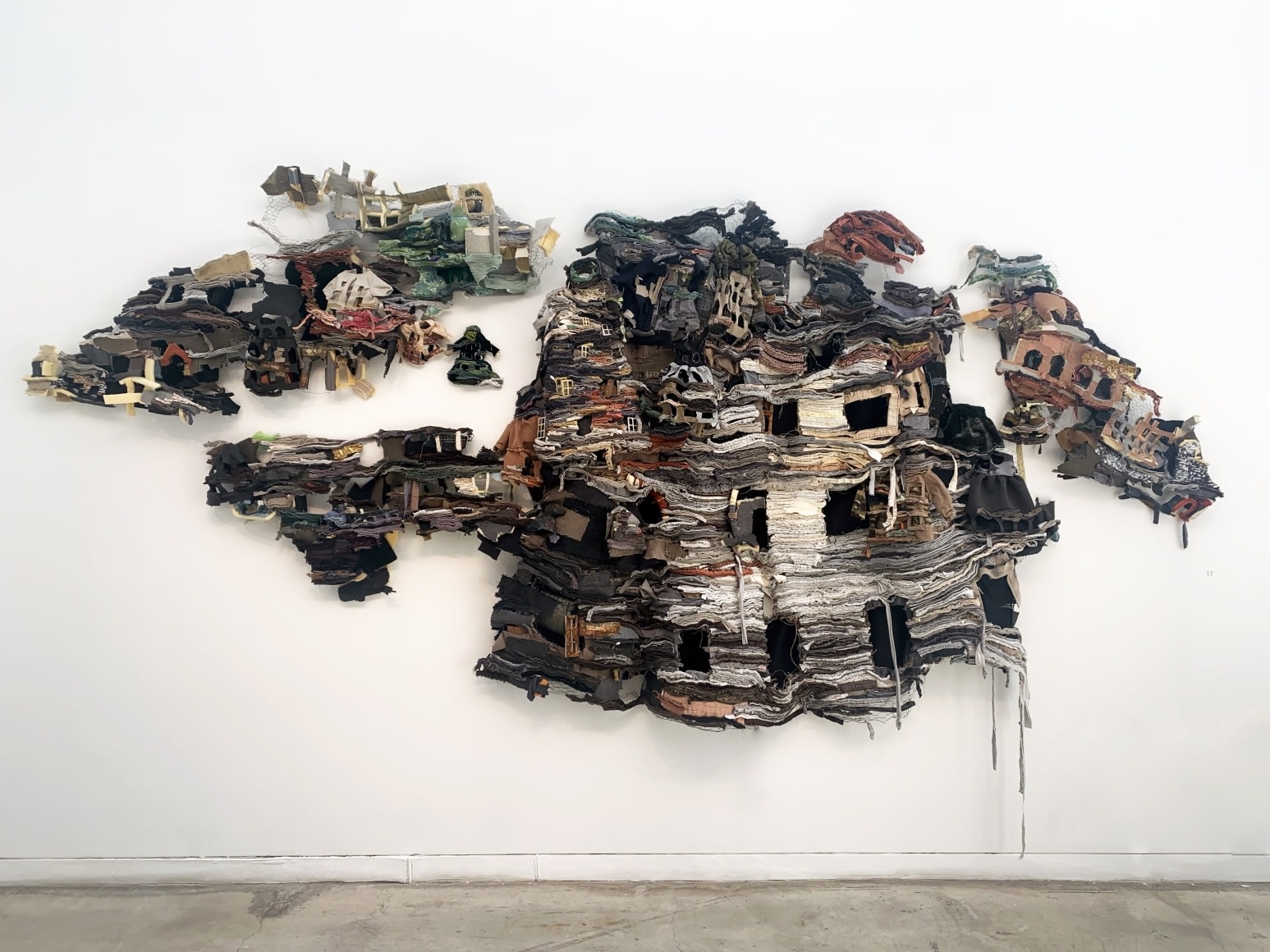 Recycled clothes, shaped to look like a group of houses.