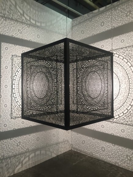 Anila Quayyum Agha Crossing Boundaries Ed. of 2 2016 Laser cut black stainless steel and bulb 48 x 48 x 48 in.