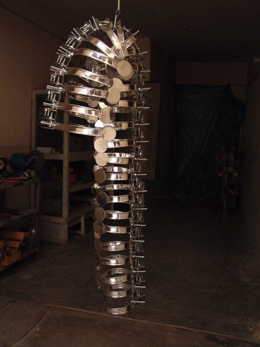 Adeela Suleman, Remains, 2008, Steel drain covers, steel tongs, nuts and bolts, 44 x 16 in
