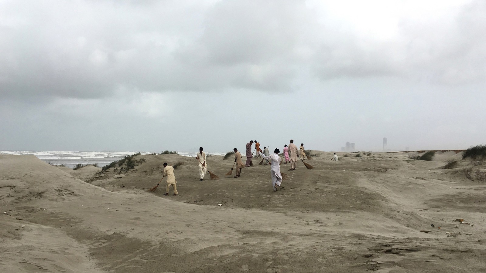 Video of people sweeping sand.