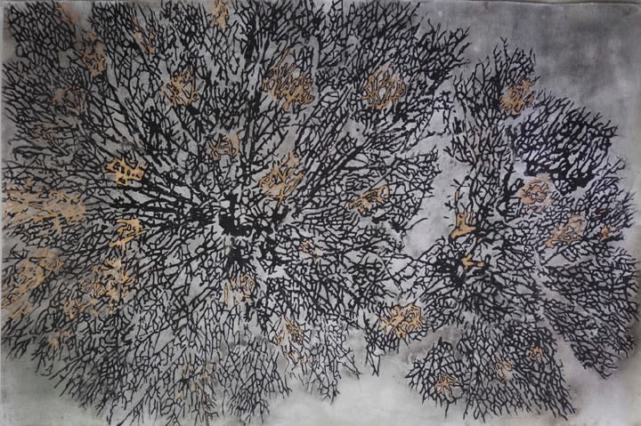 Black burnt branches over a background of grey with gold specks scattered.