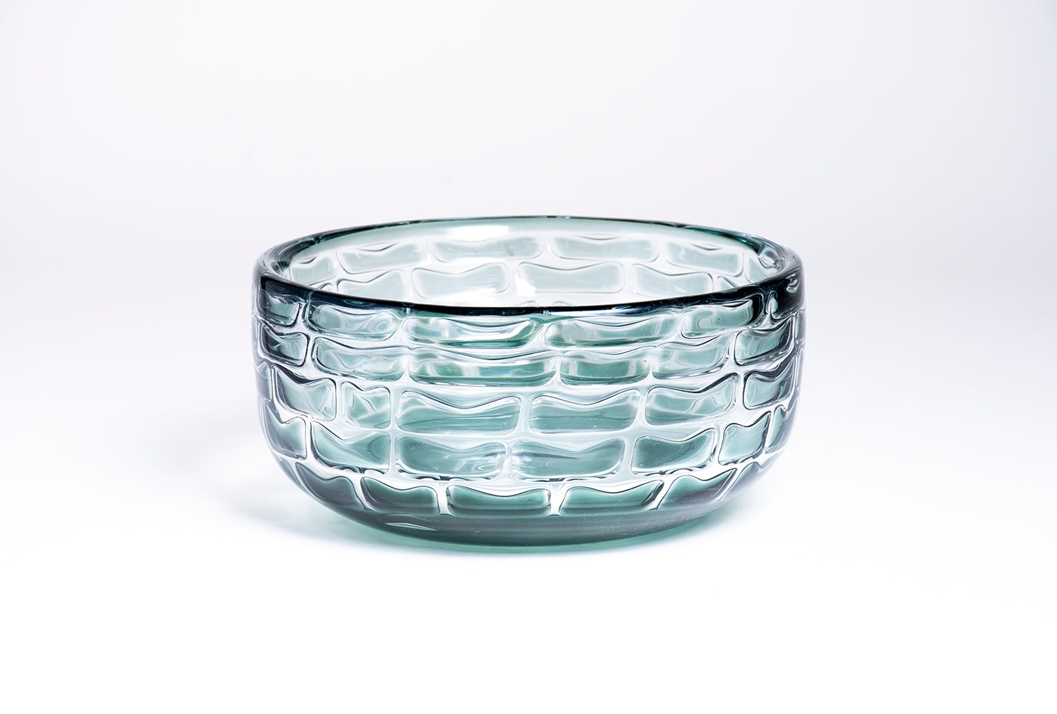 a low wide bowl, in the ariel technique by orrefors, with a brick-like pattern formed by a gray-green glass and trapped air bubbles in the swedish overlay technique