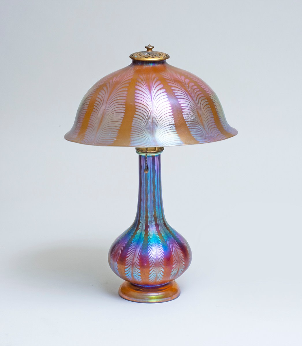 a blown favrile glass lamp by tiffany studios, iridescent rainbow glass with silvery feather stripes