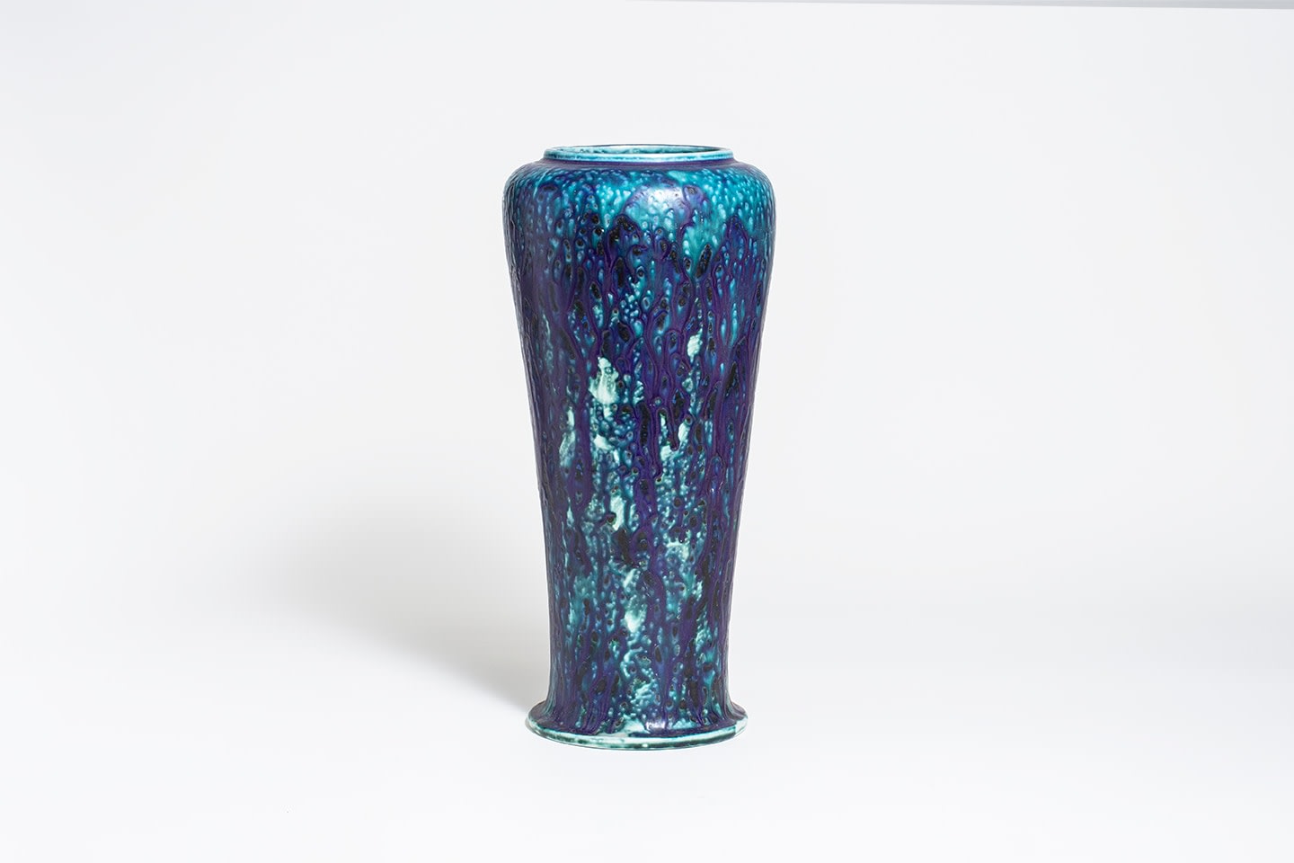 a monumental tiffany pottery vase in variegated dripping glaze ranging from soft teal to deep indigo, of classical form.