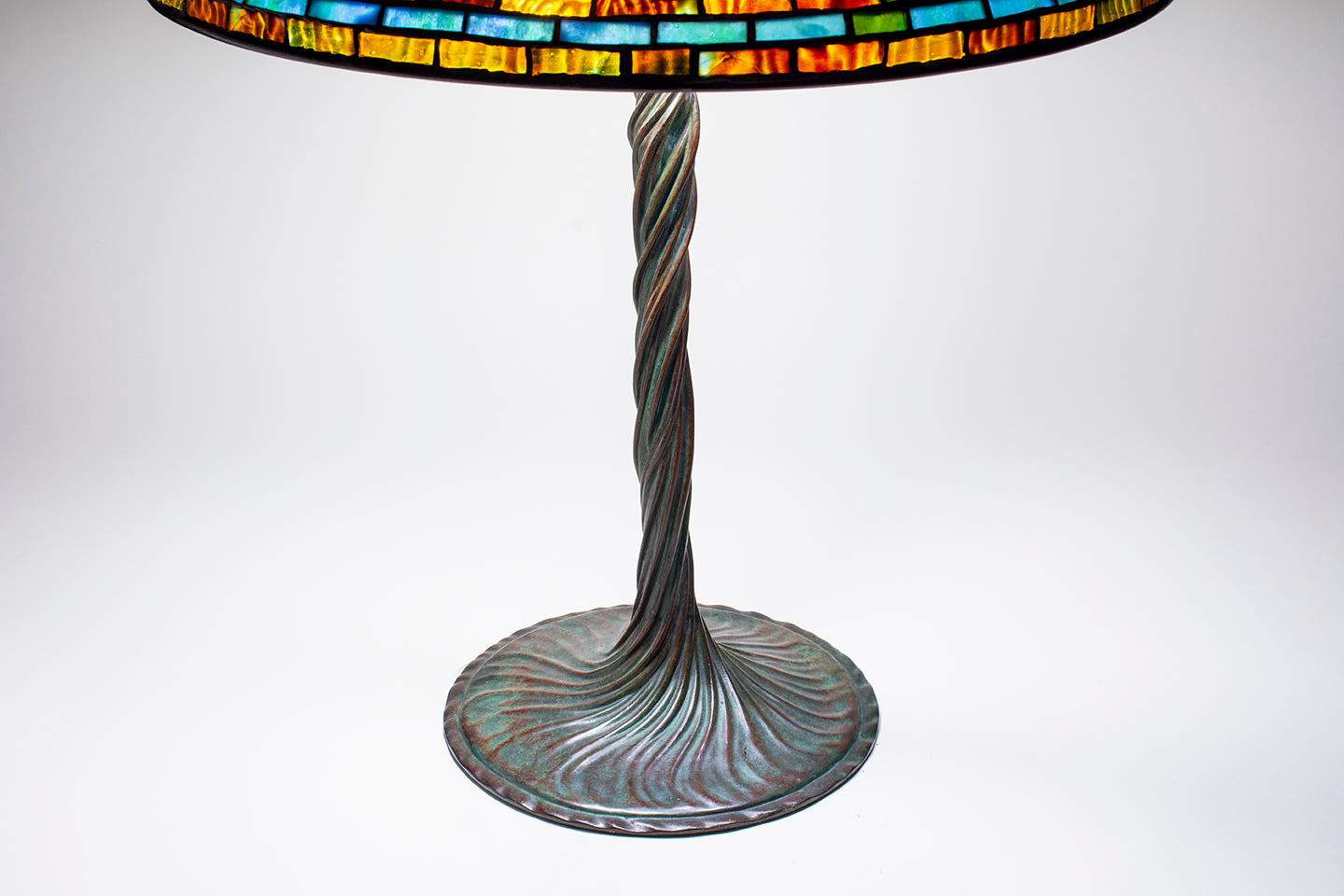 a bronze tiffany lamp base which is shaped like a twisted vine