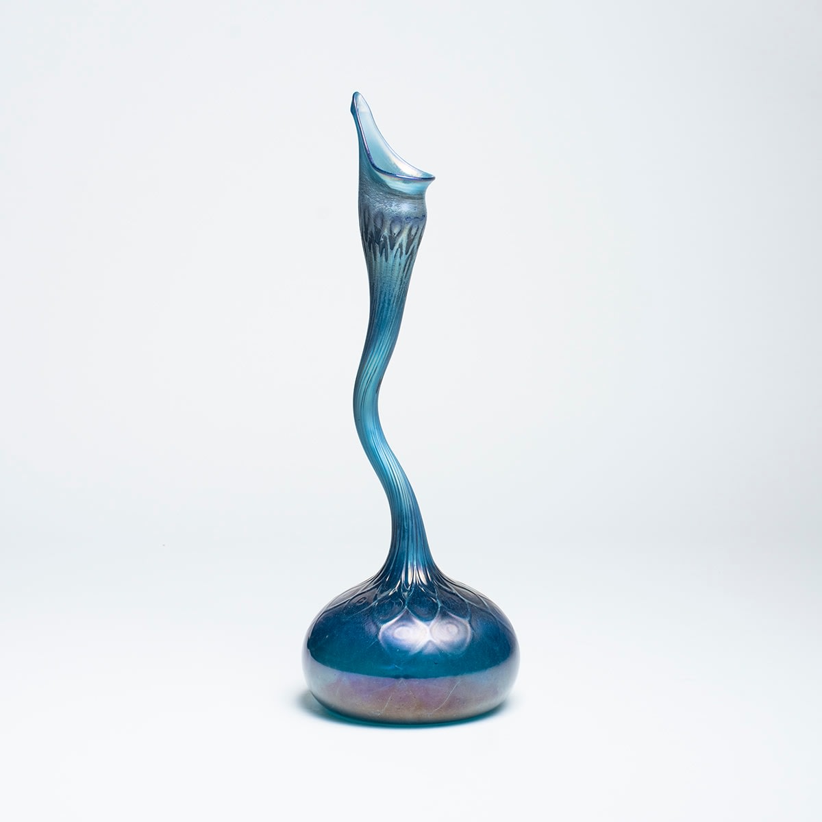 a blue iridescent gooseneck vase or rosewater sprinkler by tiffany studios in favrile glass, the form inspired by islamic historic glass
