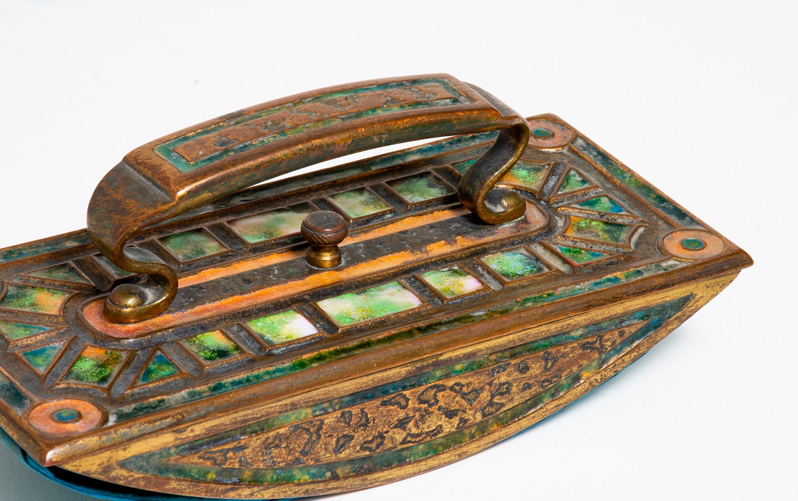 a gilt bronze &quot;rocker blotter&quot; a device used to blot excess ink, the handle and flat planes of the gilt bronze piece with inset enamel in square recesses in shades of green