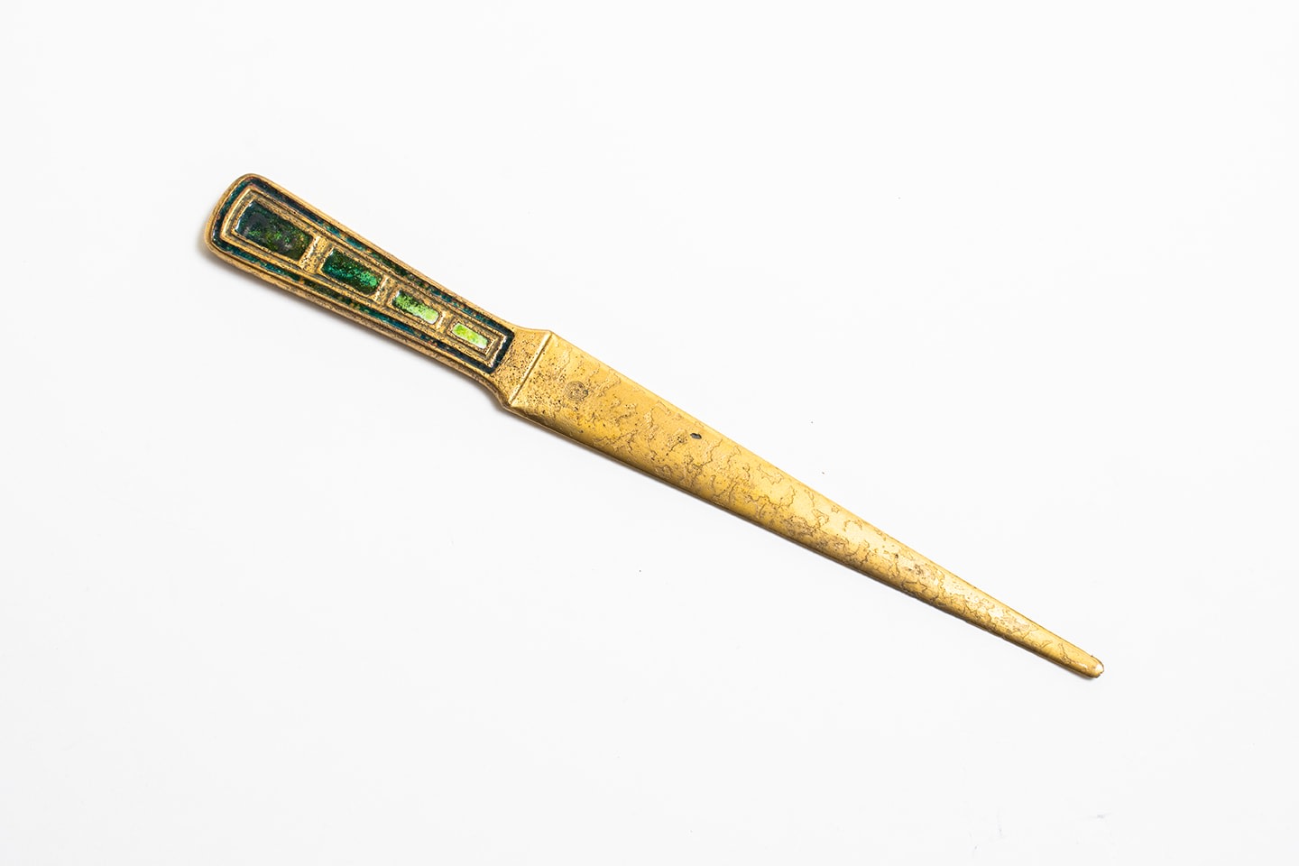 a gilt bronze letter opener or paper knife by louis c tiffany furnaces inc, a successor to tiffany studios, with a handle decorated with inset variegated green enamel in rectangular recesses.