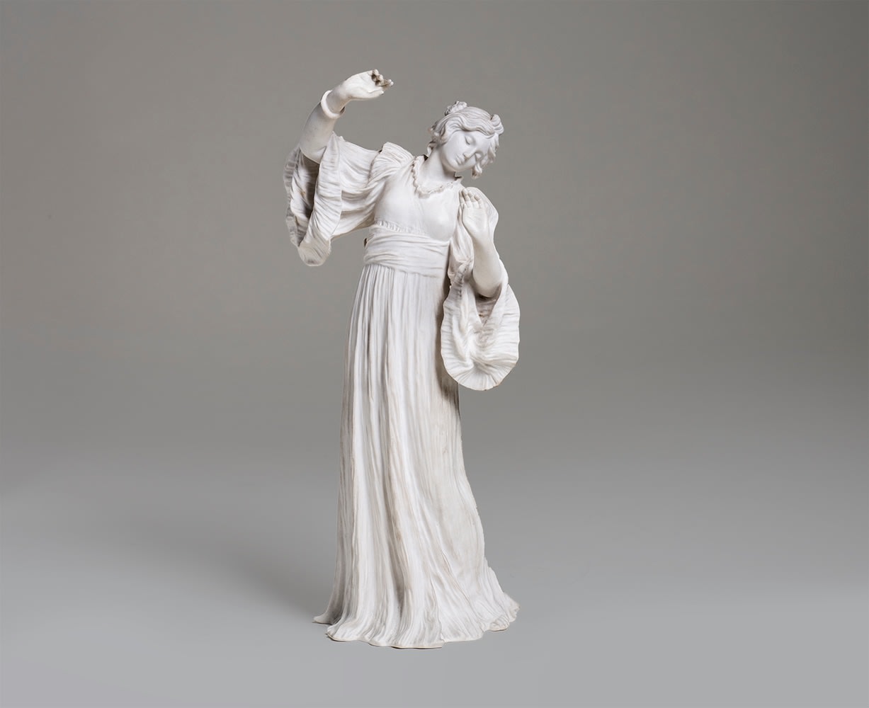 a bisque porcelain sculpture of french &quot;Scarf Dancer&quot; Loie Fuller, with her signature flowy dress with billowing sleeves giving the figure a sense of motion