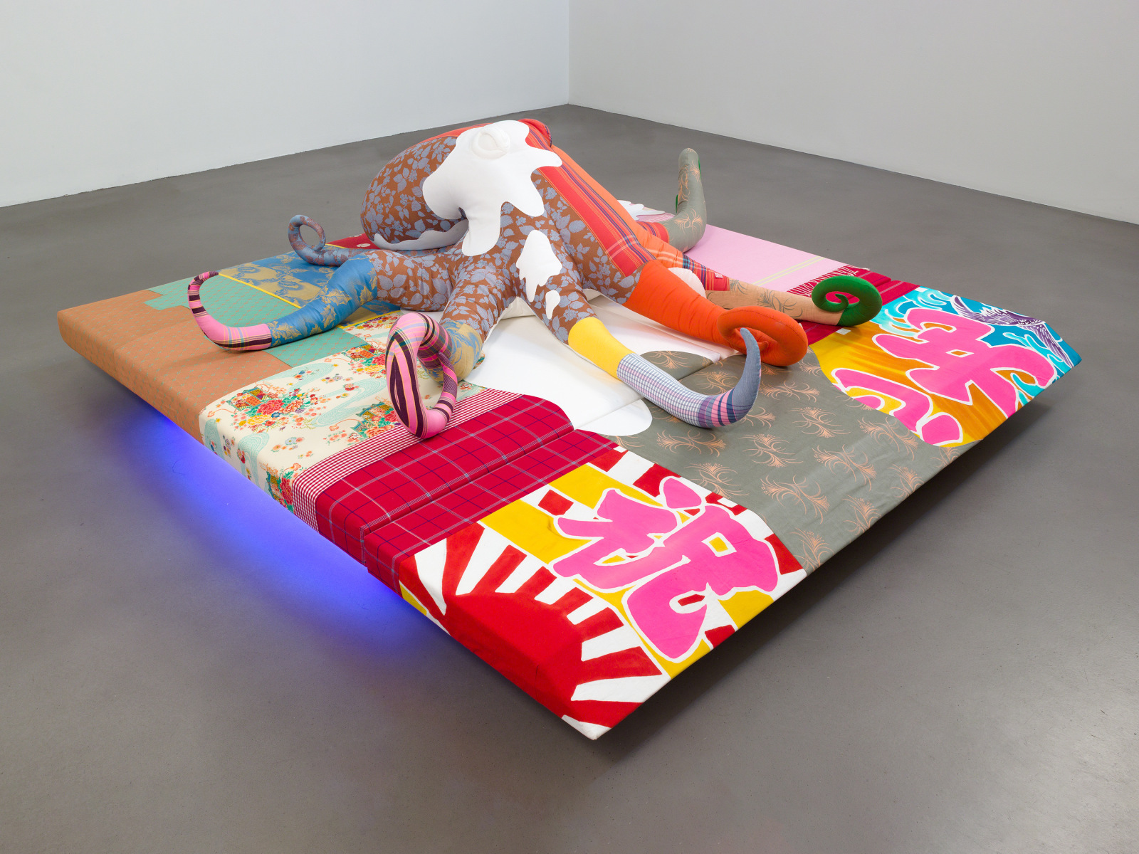 Cosima von Bonin, TOTAL PRODUCE (MORALITY), 2010, Various fabrics, polyfill, foam, rubber, wood, neon tubes,&amp;nbsp;33.5 x 98 x 98 inches, 85 x 230 x 250 cm