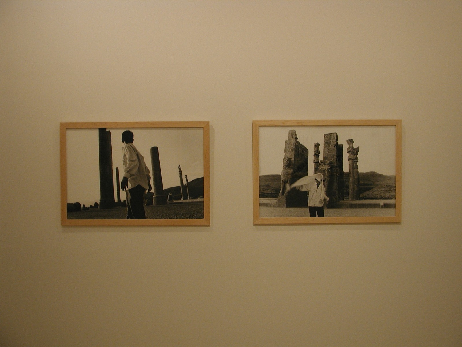 Two framed black and white photographs of a man standing in front of stone columns in the exhibition Sadegh Tirafkan at Lehmann Maupin in New York in 2004