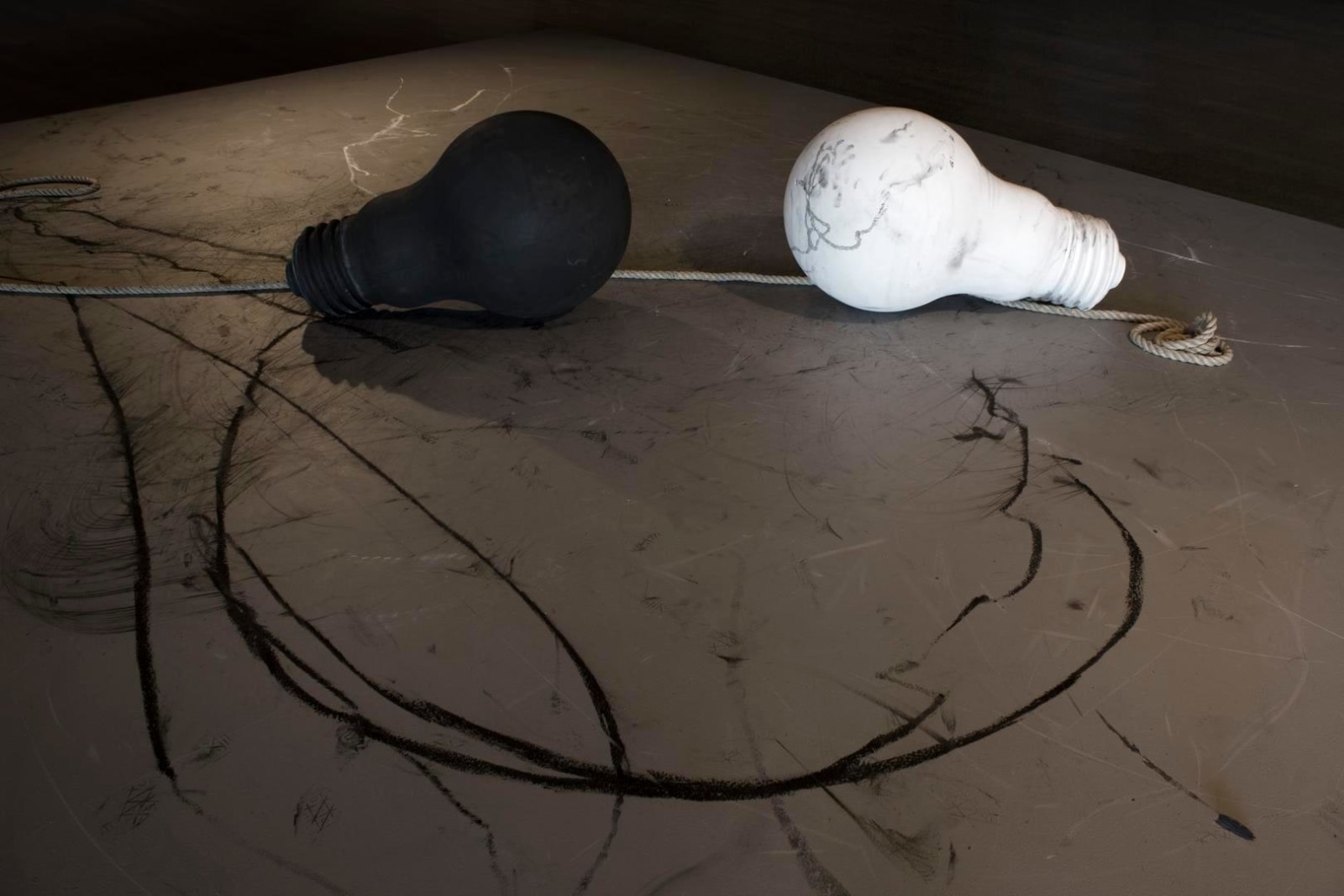 Installation view of Robin Rhode: The Sudden Walk (Kulturhuset Stadsteatern, Stockholm, February 14-May 3, 2015). &nbsp;Detail: Light Giver Light Taker, 2015, black lightbulb: polyurethane foam, charcoal; white lightbulb: polyurethane foam, chalk.&nbsp;
