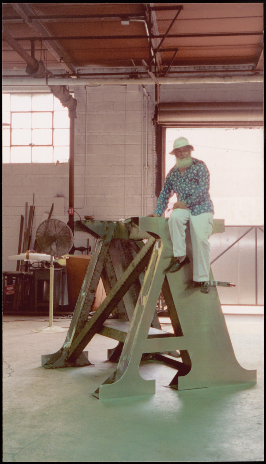 Indiana with a section of The Indiana Obelisk (2002), photographed while the sculpture was being fabricated at Milgo/Bufkin in Brooklyn, New York, 2001