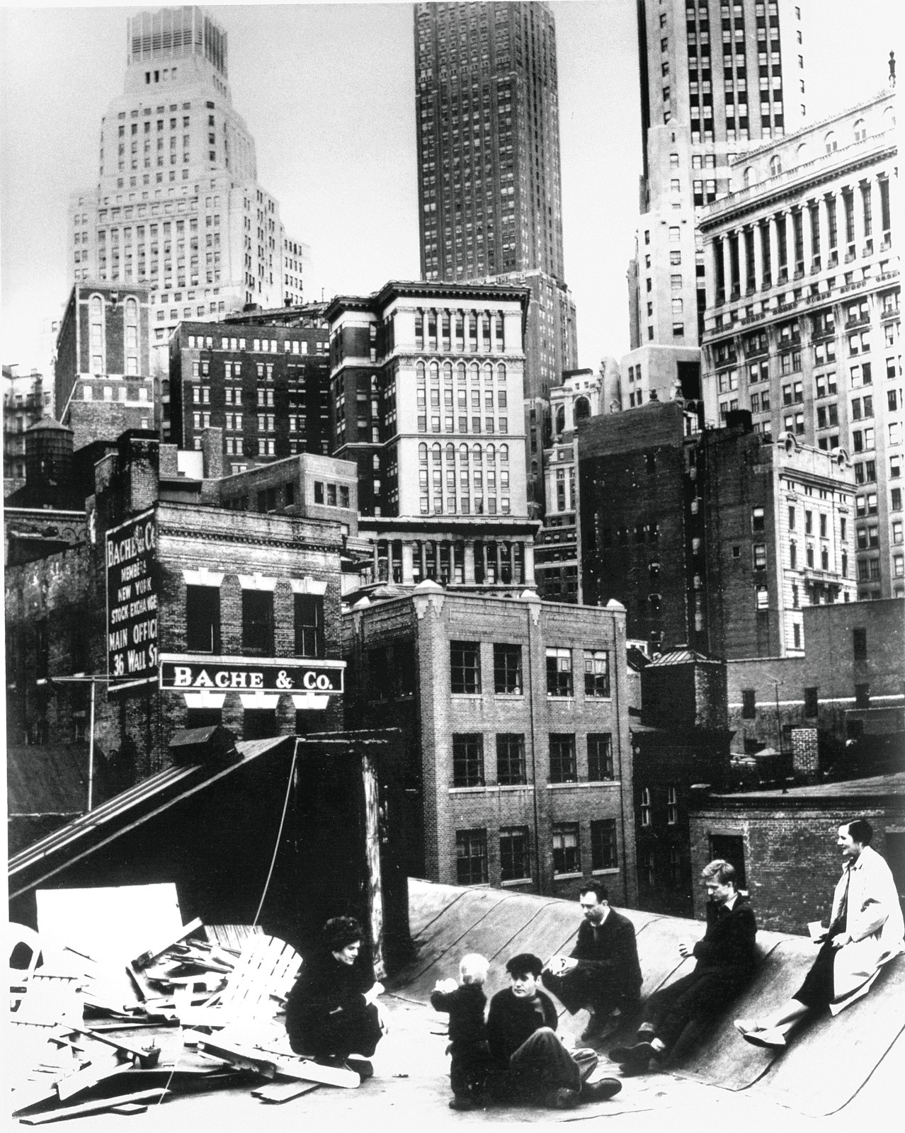 A black and white photograph of Indiana and other artists sitting on the roof of 3-5 Coenties Slip