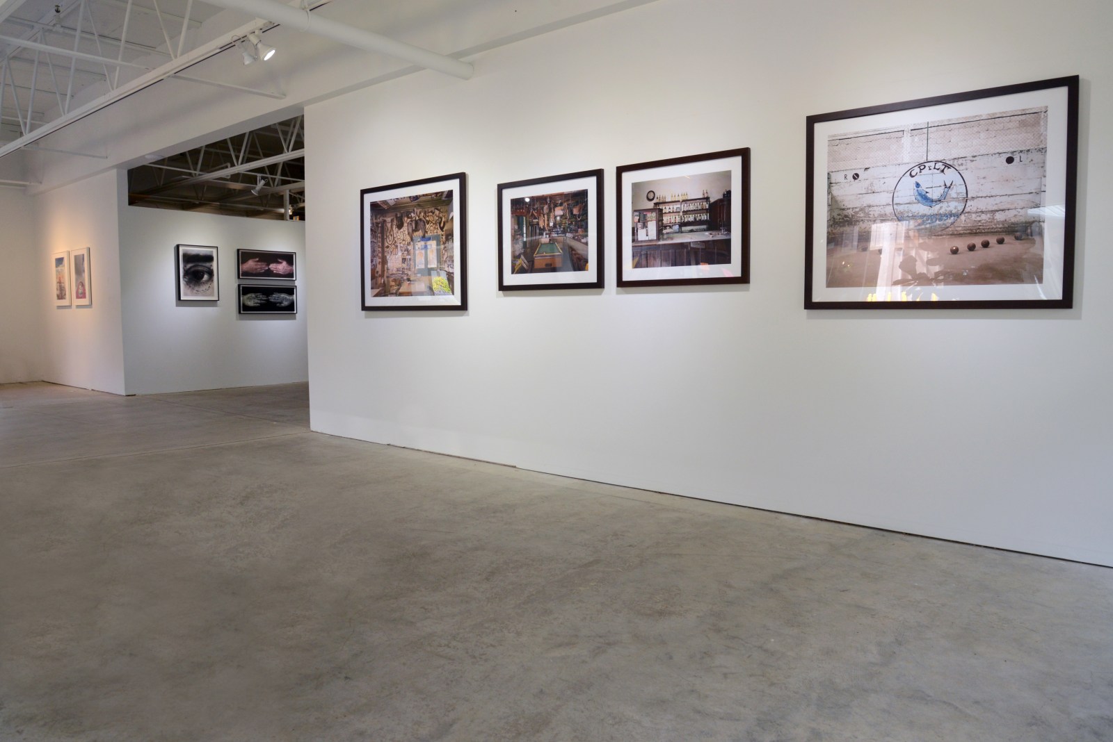 Gallery installation view of several photographs framed and hanging on gallery walls
