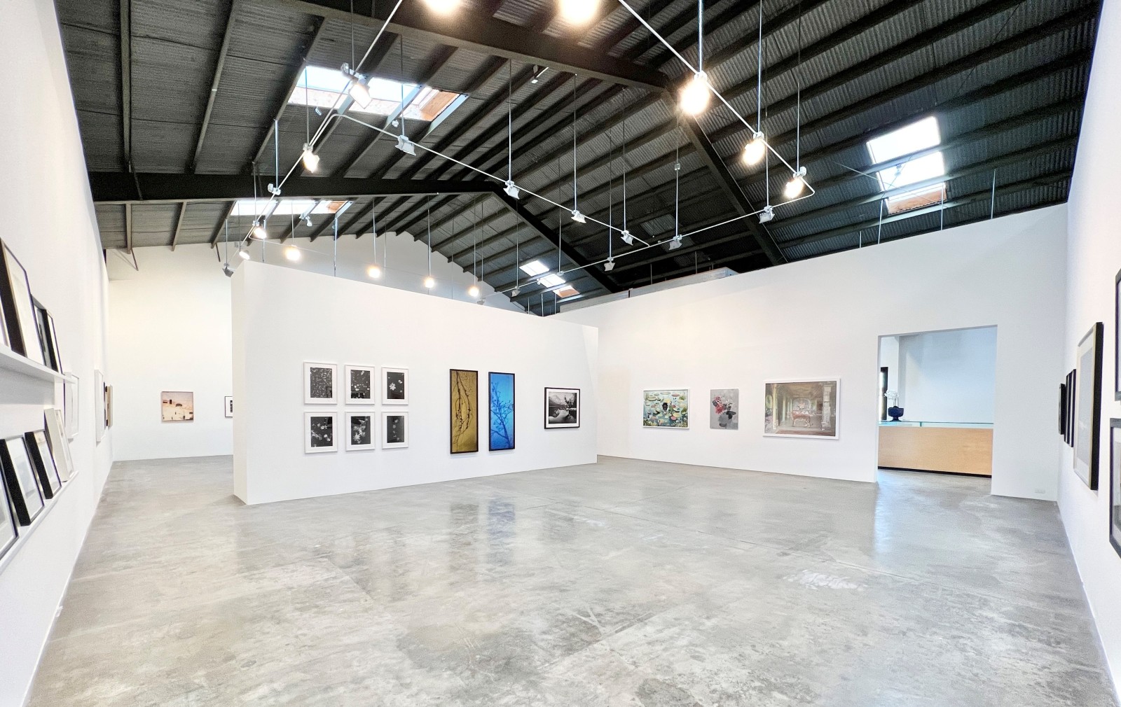 Installation view of Danziger Gallery with framed photographs hanging on walls.